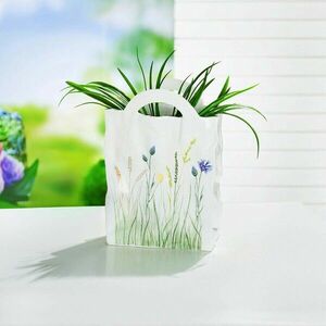 Dekoratív virágtartó Táska virágokkal kép